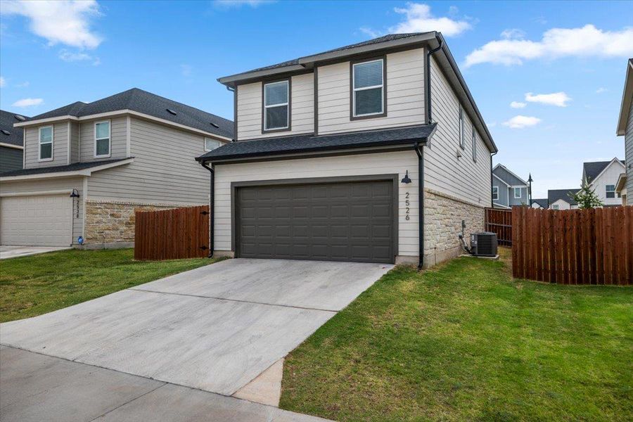 A well-maintained two-story home with an attached garage and privacy fencing awaits.