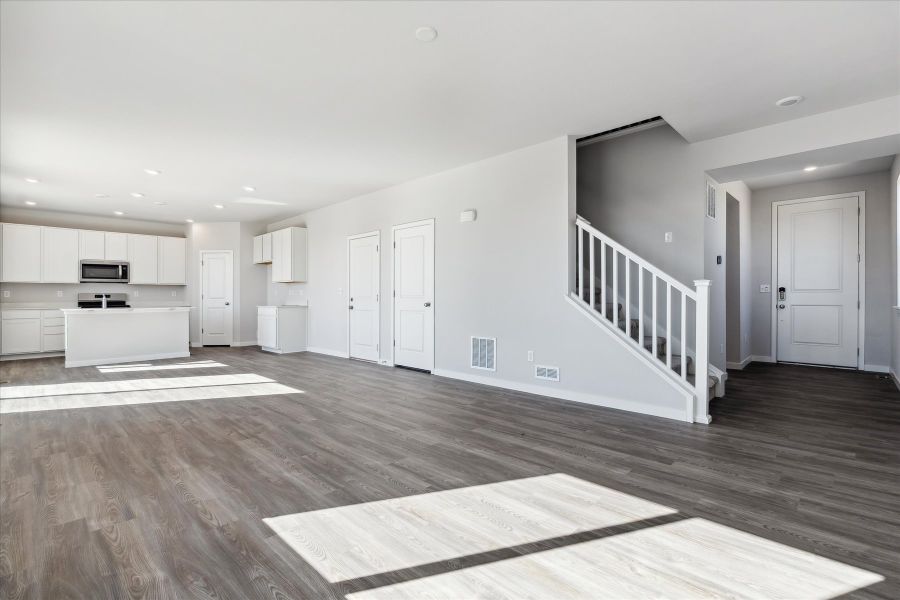 A room with white walls and wood floors.