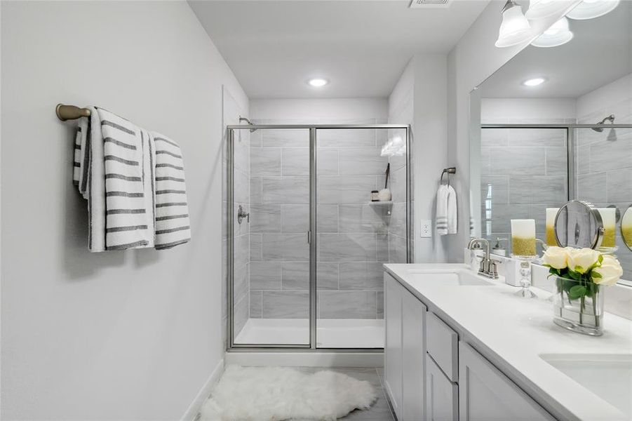 Bathroom featuring vanity and a shower with shower door