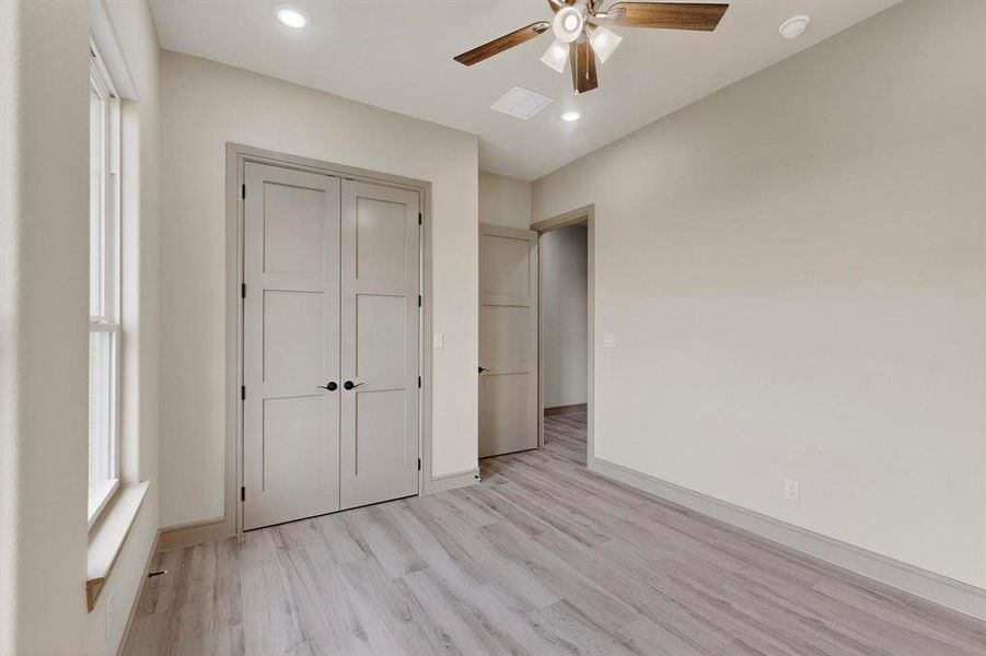 Unfurnished bedroom featuring light wood-style floors, a ceiling fan, a closet, and recessed lighting Unfurnished bedroom featuring light wood-style floors, a ceiling fan, a closet, and recessed lighting