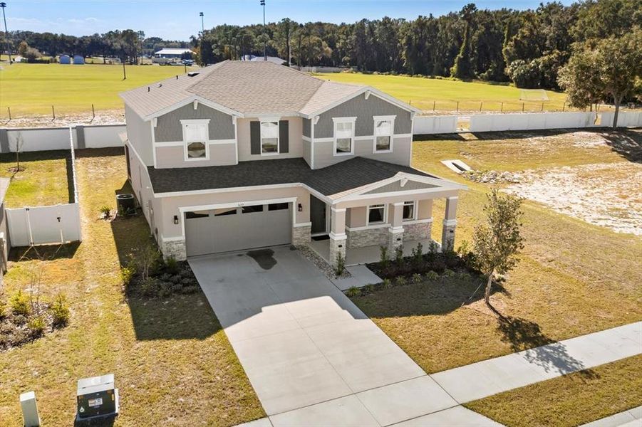 Front exterior of a new home in Seasons at Lakeside Forest, Tavares, FL, highlighting curb appeal (Image 23).