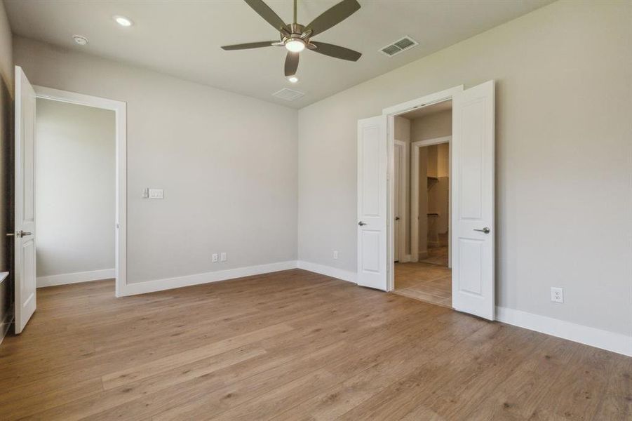 Unfurnished bedroom featuring light hardwood / wood-style flooring and ceiling fan