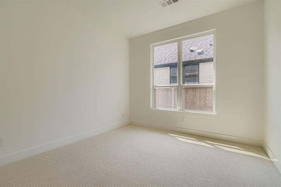 Carpeted empty room featuring baseboards Carpeted empty room featuring baseboards