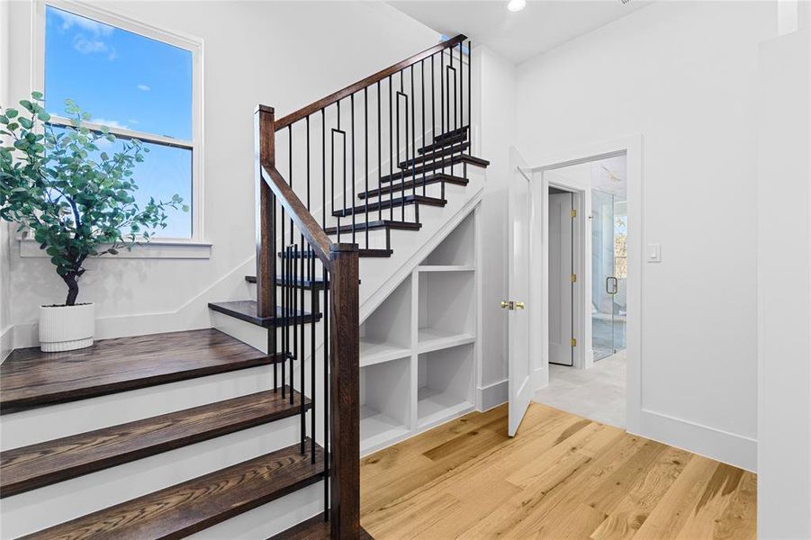 Staircase featuring wood finished floors, plenty of natural light, and recessed lighting and lead to her closet on the 2nd floor. Staircase featuring wood finished floors, plenty of natural light, and recessed lighting and lead to her closet on the 2nd floor.