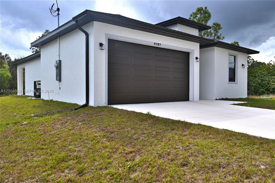 Front exterior of a new home in , Lehigh Acres, FL, highlighting curb appeal (Image 23).