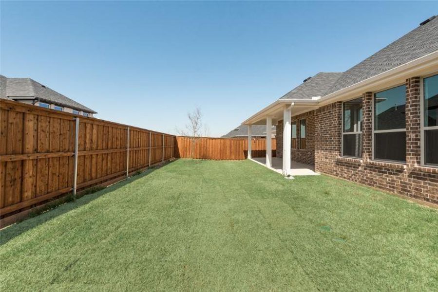 Exterior details and patio area of a home in Spiritas Ranch, Little Elm (Image 4).