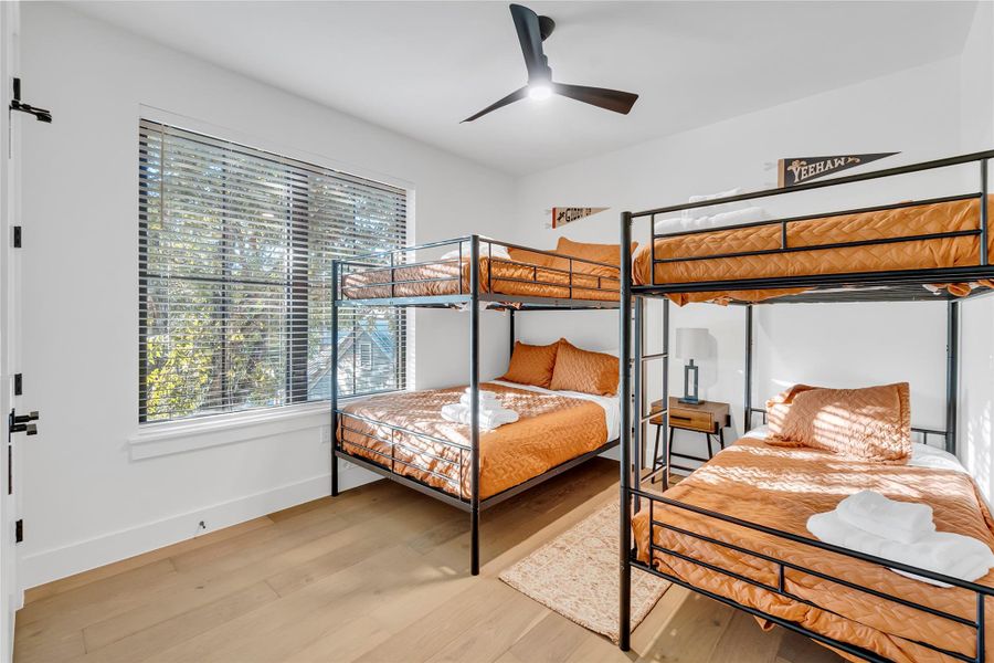 Bedroom featuring ceiling fan and light wood-style floors Bedroom featuring ceiling fan and light wood-style floors