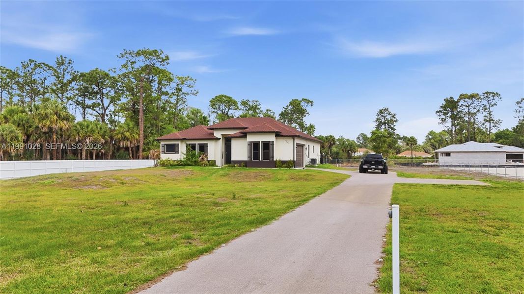 Front exterior of a new home in , Naples, FL, highlighting curb appeal (Image 25).