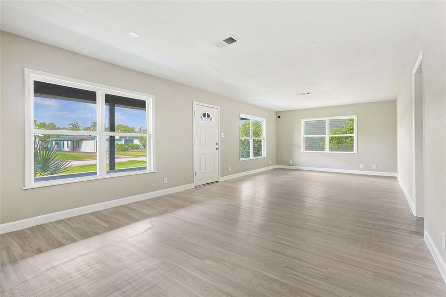 This expansive entryway offers ample space for elegant living and dining areas.