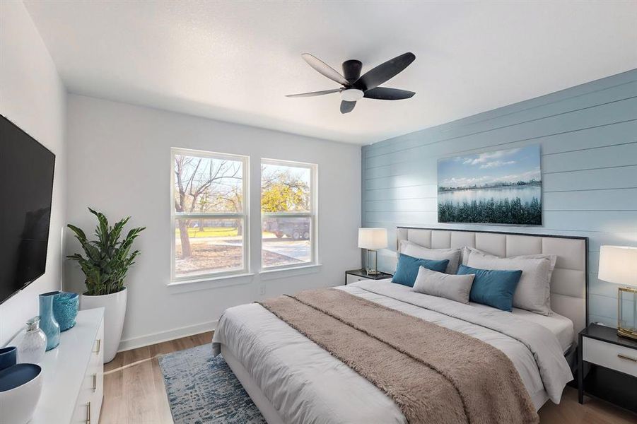 Bedroom featuring light hardwood / wood-style floors, ceiling fan, and wood walls