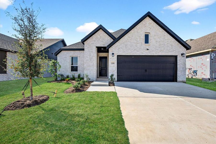 Front exterior of a new home in Hickory Hill, Sherman, TX, highlighting curb appeal (Image 22). Front exterior of a new home in Hickory Hill, Sherman, TX, highlighting curb appeal (Image 22).