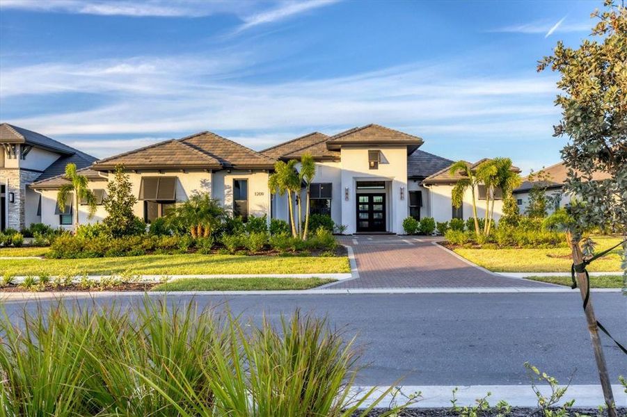 Front exterior of a new home in Wild Blue at Waterside, Sarasota, FL, highlighting curb appeal (Image 24).