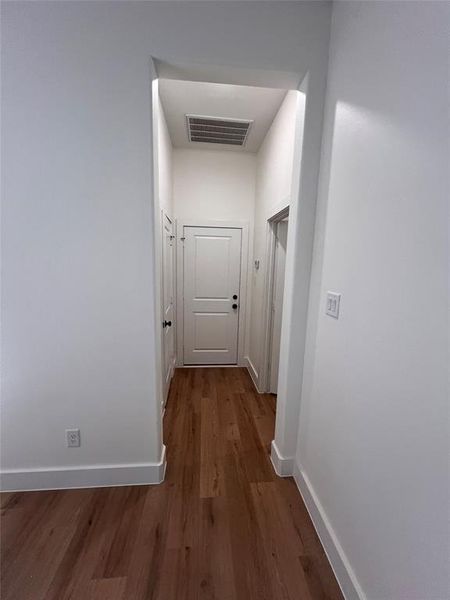 Hall with hardwood / wood-style flooring