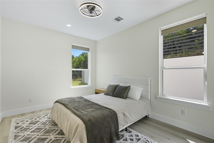 Bedroom with light wood-type flooring and recessed lighting