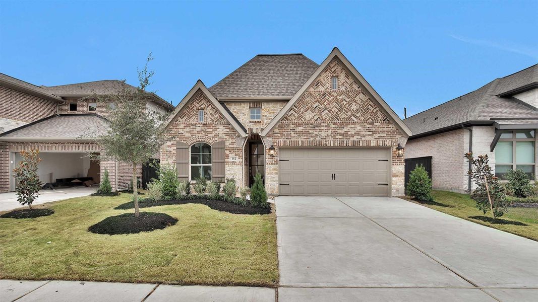 Front exterior of a new home in Harvest Green 45', Richmond, TX, highlighting curb appeal (Image 1). Front exterior of a new home in Harvest Green 45', Richmond, TX, highlighting curb appeal (Image 1).