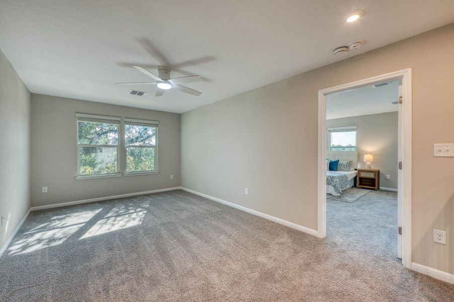 Soft carpeting underfoot defines this versatile bedroom space, connected seamlessly to an adjacent suite. Soft carpeting underfoot defines this versatile bedroom space, connected seamlessly to an adjacent suite.