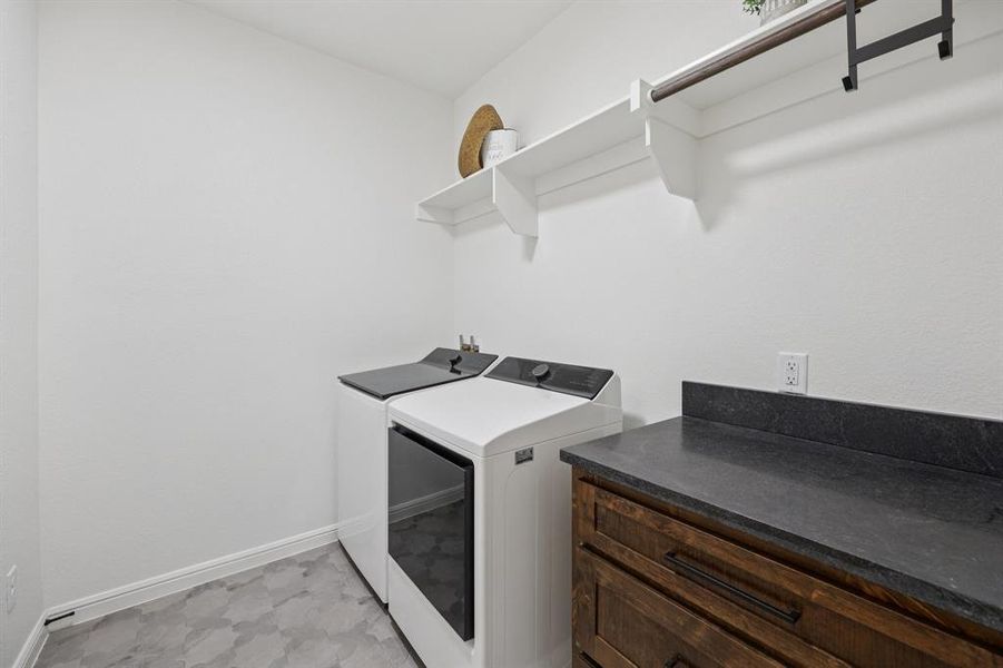 Laundry room featuring baseboards and washer and dryer Laundry room featuring baseboards and washer and dryer