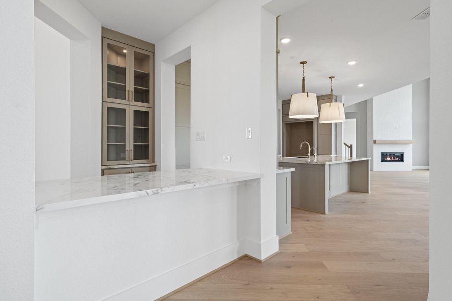 Beautifully designed butler’s pantry connects the kitchen and formal dining. Beautifully designed butler’s pantry connects the kitchen and formal dining.