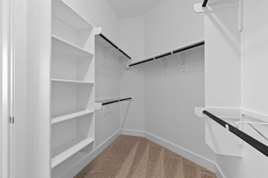 Walk-in closet in Primary Bedroom Walk-in closet in Primary Bedroom