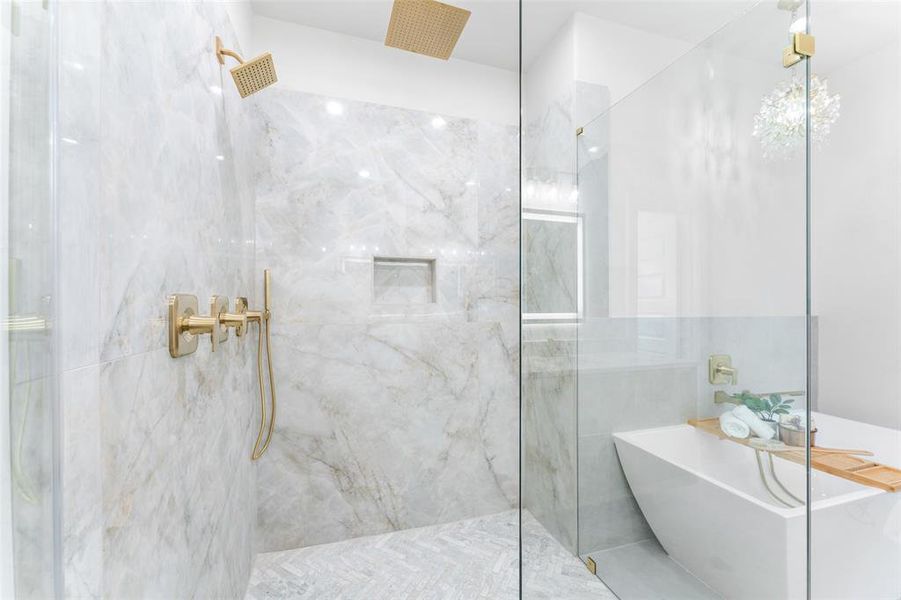Bathroom featuring a marble finish shower and a freestanding bath