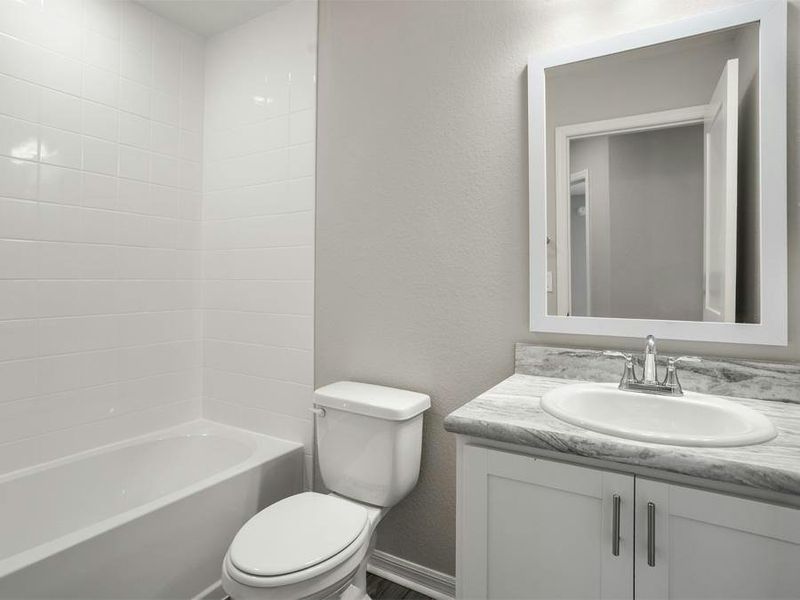 An upstairs hall bath serves bedroom 4 and the loft - Seabrooke ll by Highland Homes