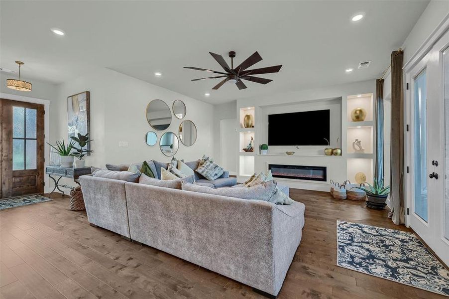 Living room featuring hardwood / wood-style floors and ceiling fan