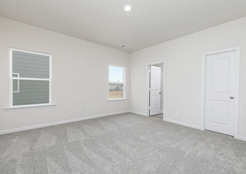 Rest and relaxation await in the master bedroom