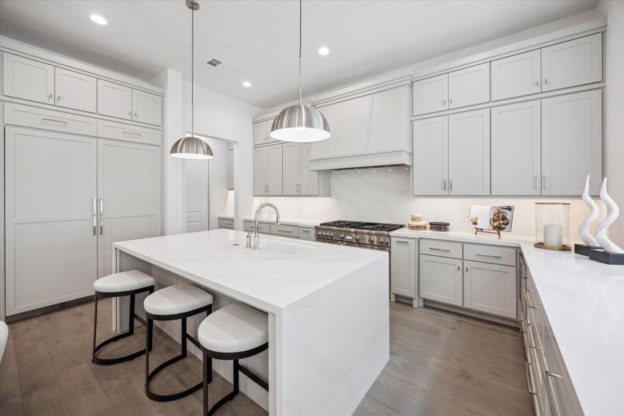 The kitchen showcases a premium Thermador appliance package, which includes a 48” Pro Harmony gas range, a 24” built-in MicroDrawer microwave, a 24” custom panel dishwasher, a 30” custom panel fresh food refrigerator, and 30” freezer columns. The kitchen showcases a premium Thermador appliance package, which includes a 48” Pro Harmony gas range, a 24” built-in MicroDrawer microwave, a 24” custom panel dishwasher, a 30” custom panel fresh food refrigerator, and 30” freezer columns.