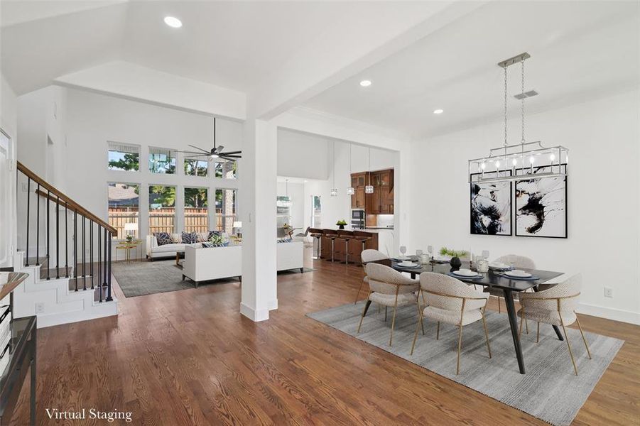 Dining area featuring dark wood finished floors, stairs, recessed lighting, beam ceiling, and ceiling fan