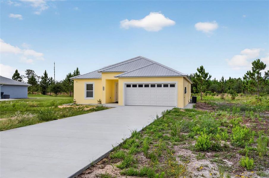 Front exterior of a new home in , Indian Lake Estates, FL, highlighting curb appeal (Image 17). Front exterior of a new home in , Indian Lake Estates, FL, highlighting curb appeal (Image 17).