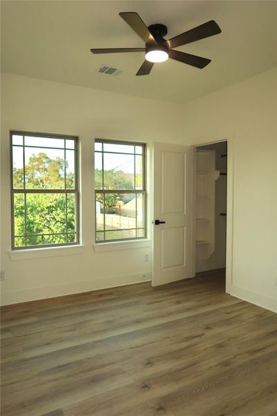 Bedroom 2 upstairs featuring a ceiling fan, 2 windows & a walk in closet. Bedroom 2 upstairs featuring a ceiling fan, 2 windows & a walk in closet.