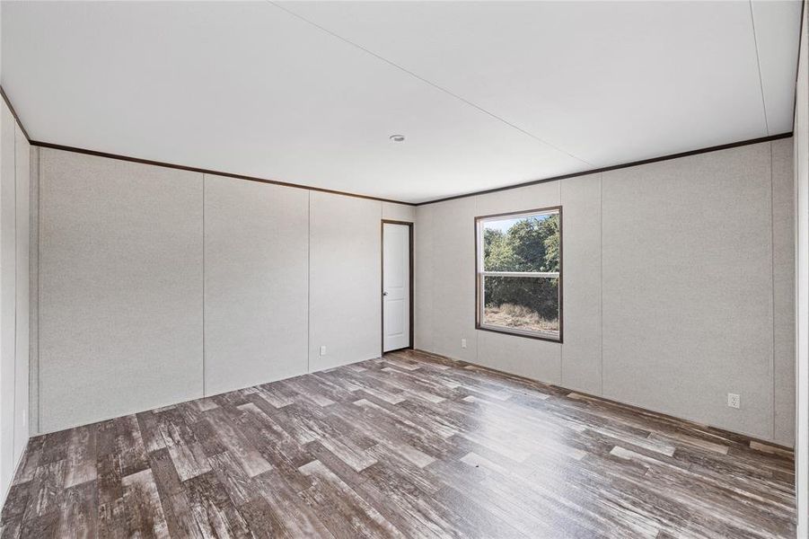 Unfurnished bedroom with wood-type flooring