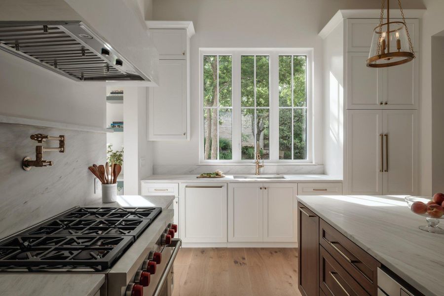 High powered dual motor vent hood with make-up air. Pot filler and quartz backsplash with a spice ledge.