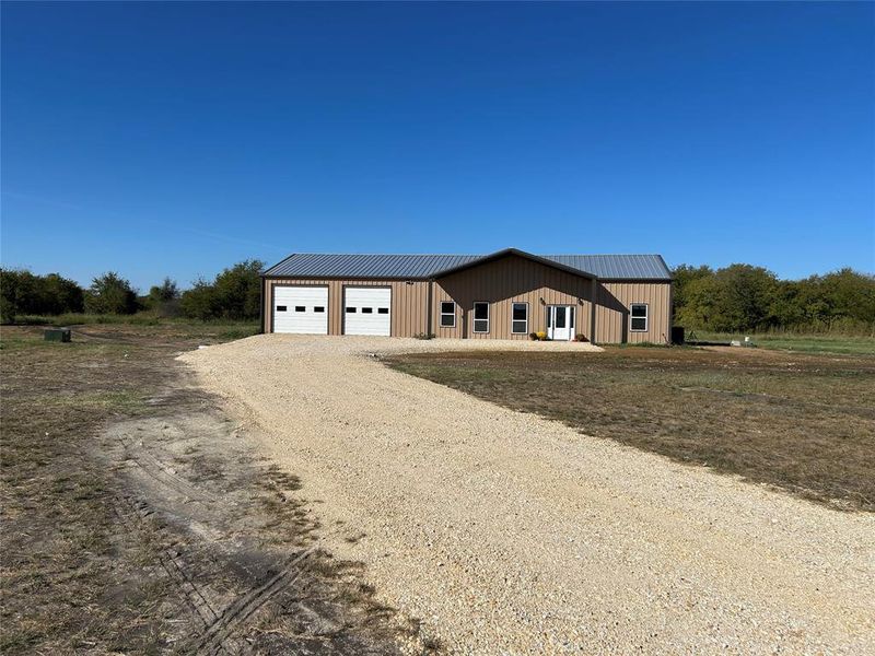 Modern inspired farmhouse with driveway and a garage