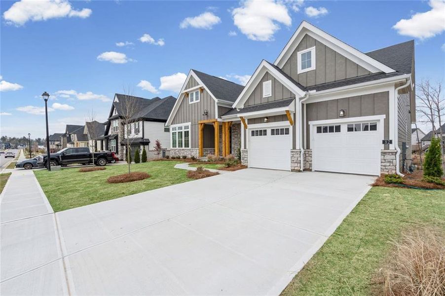 Front exterior of a new home in Twin Lakes, Hoschton, GA, highlighting curb appeal (Image 2). Front exterior of a new home in Twin Lakes, Hoschton, GA, highlighting curb appeal (Image 2).