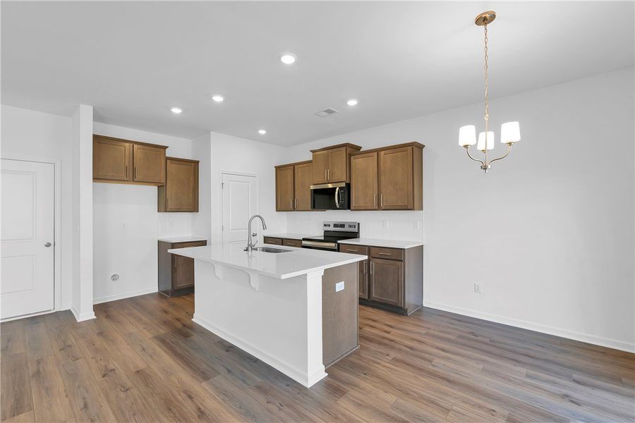 This bright kitchen features sleek appliances, an