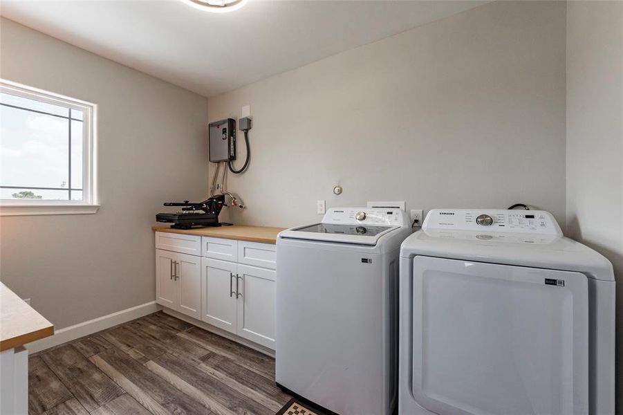 Utility room includes the on demand tankless water heater, plumbed to add a sink with seperate folding/storage area. Washer and Dryer convey with sale