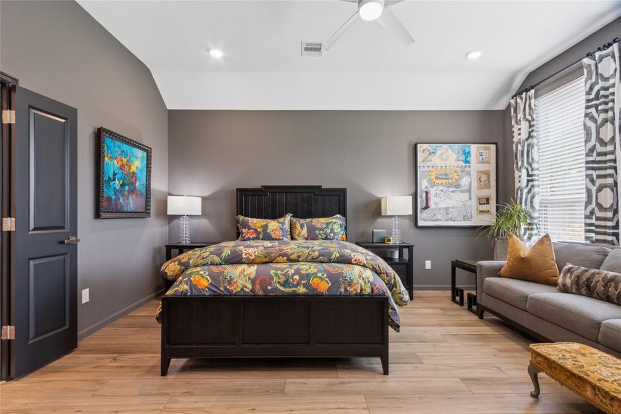 Primary suite with room for a sitting area along the wall of windows