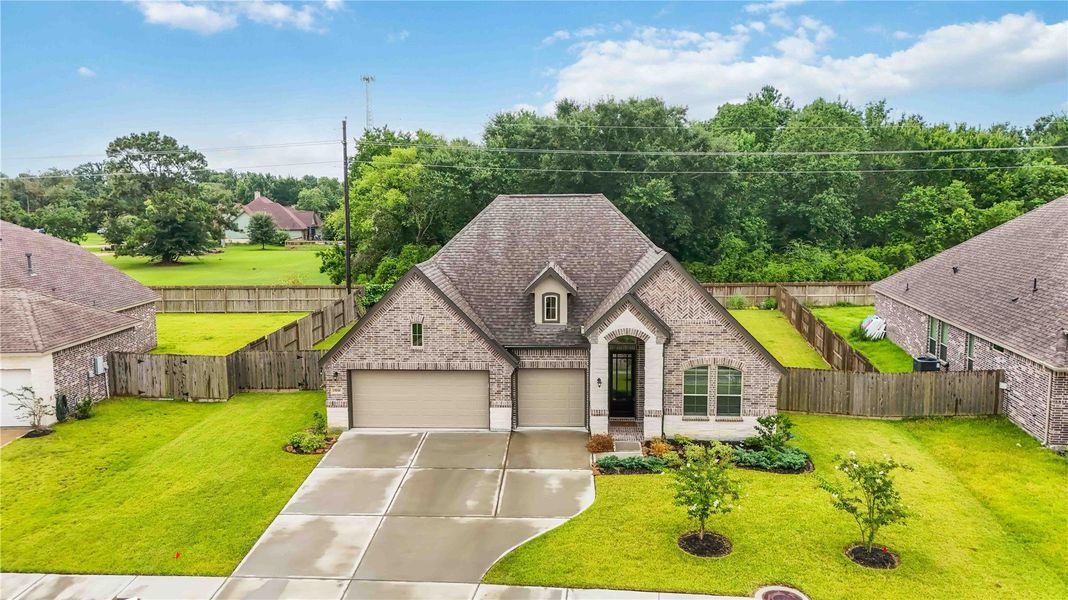 Front exterior of a new home in Lakes of Champion's Estates, Mont Belvieu, TX, highlighting curb appeal (Image 2). Front exterior of a new home in Lakes of Champion's Estates, Mont Belvieu, TX, highlighting curb appeal (Image 2).