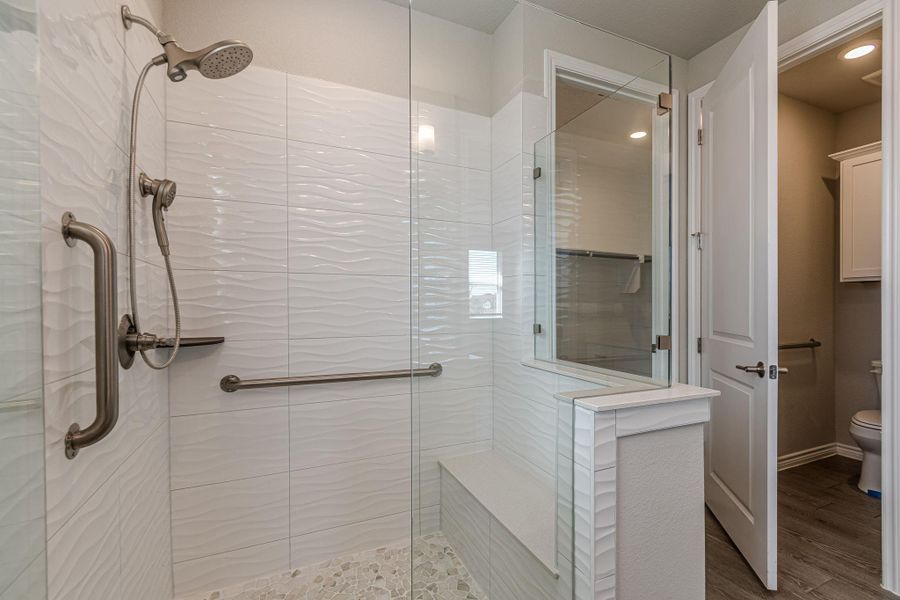 Bathroom featuring walk in shower and wood finished floors Bathroom featuring walk in shower and wood finished floors