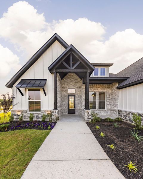 Front exterior of a new home in Prairie Winds Estates, Poolville, TX, highlighting curb appeal (Image 5). Front exterior of a new home in Prairie Winds Estates, Poolville, TX, highlighting curb appeal (Image 5).