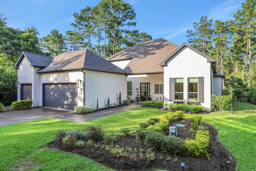 Nestled on a private, wooded lot with no rear neighbors, the property offers exceptional curb appeal, a spacious three-car garage, and a welcoming covered front porch that perfectly blends timeless elegance with contemporary style.