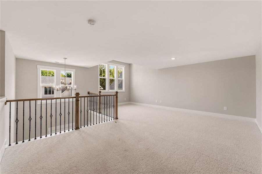 A spacious upper-level loft area offers abundant n