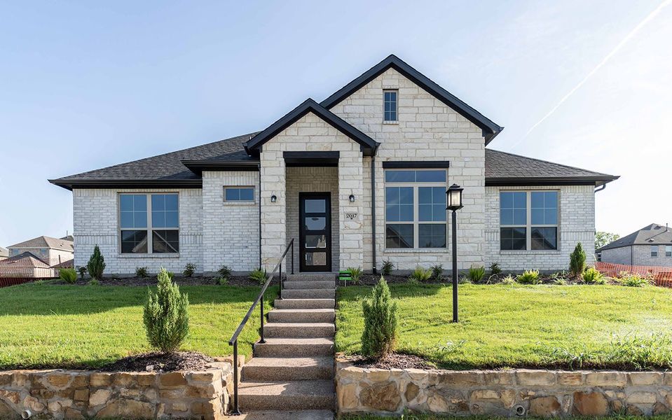 Front exterior of a new home in Solterra, Mesquite, TX, highlighting curb appeal (Image 1). Front exterior of a new home in Solterra, Mesquite, TX, highlighting curb appeal (Image 1).