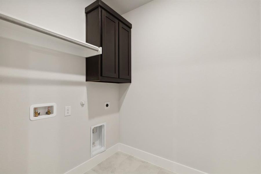 Laundry area with cabinet space, baseboards, gas dryer hookup, washer hookup, and electric dryer hookup