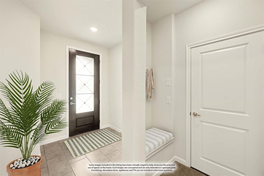 Entryway with dark front door, glass panel, tile floors, and built-in bench seat in mudroom area Entryway with dark front door, glass panel, tile floors, and built-in bench seat in mudroom area