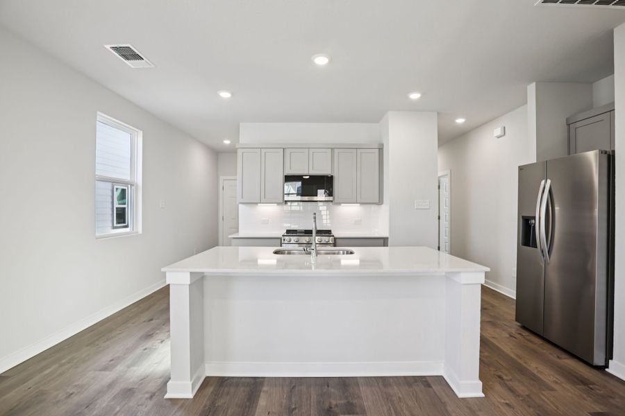 A kitchen with white cabinets. A kitchen with white cabinets.