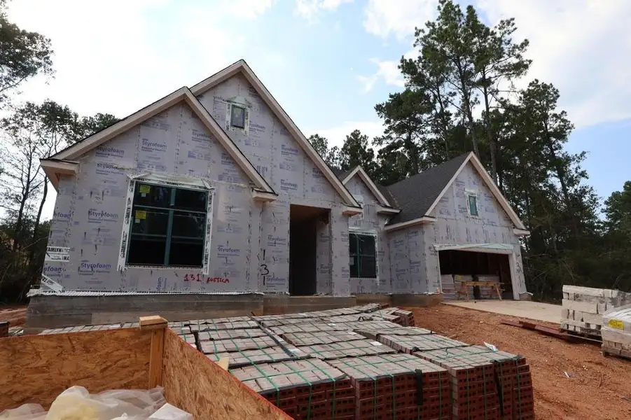 Front exterior of a new home in The Woodlands Hills 70’, Willis, TX, highlighting curb appeal (Image 1).
