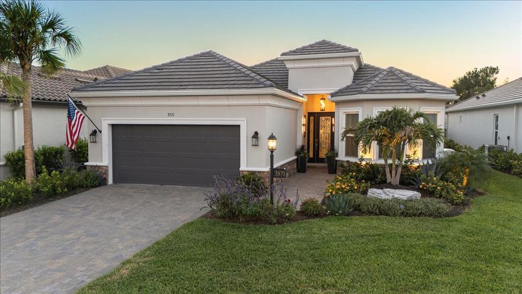 Front exterior of a new home in Esplanade at Azario Lakewood Ranch, Bradenton, FL, highlighting curb appeal (Image 21).