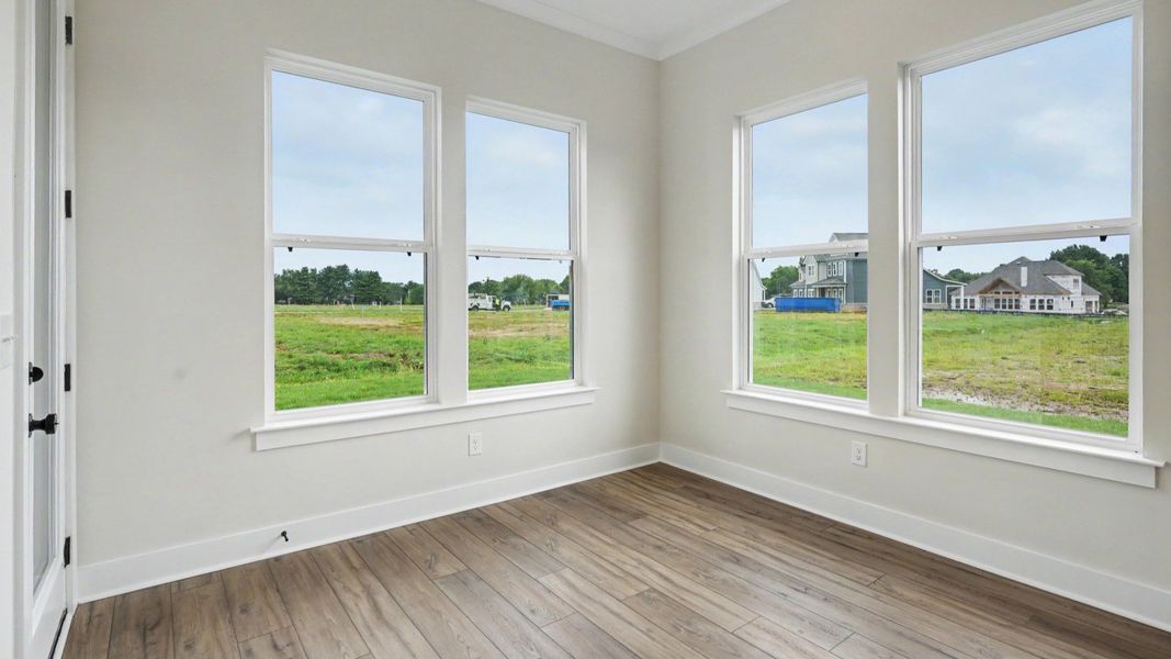 First floor area with hard-surface flooring and windows